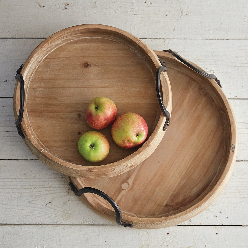 Round wood tray with black metal handles and angled lip. 2 sizes available.