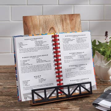 Wooden cookbook holder with black metal holder.