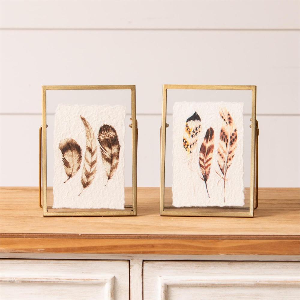Set of 2 feather prints in gold frames with easels and glass. he prints are printed on torn handmade paper.