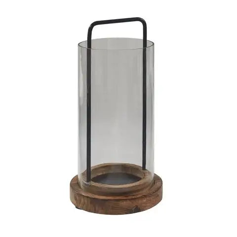 Mason lantern made of mango wood base with sleek metal handle attached to base that holds glass cylinder.