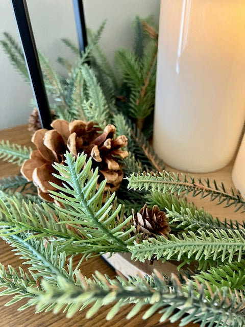 Close up of pine and pinecones in candle ring