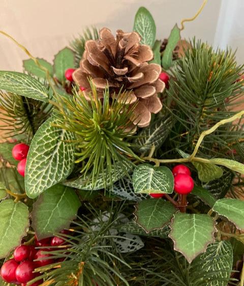 Close up of mixture of pine,
berries, holly, and pinecones