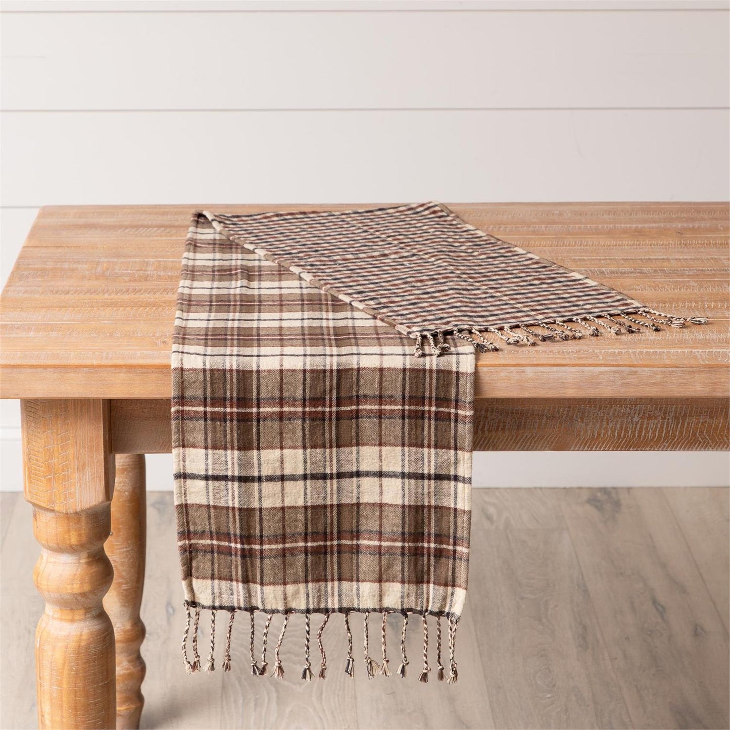 Table runner in a brown plaid pattern on one side other side is a brown checked pattern. Made of soft brushed cotton fabric.