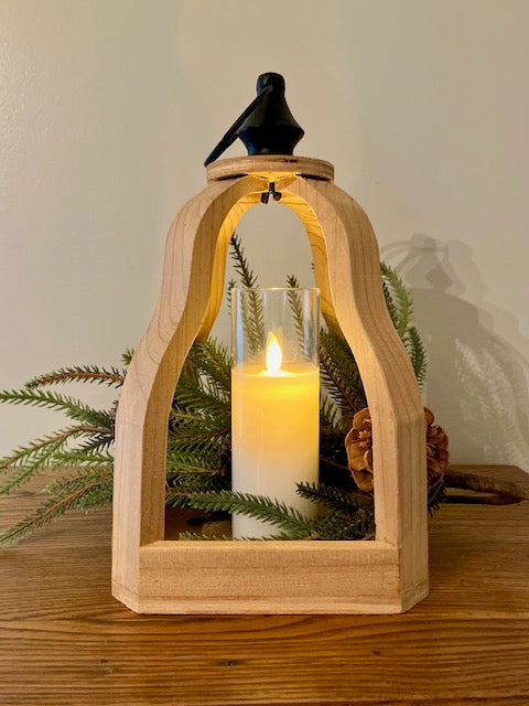 Open wood lantern with black metal finial with ring to hang. Shown with norfolk pine stem and cream led candle.