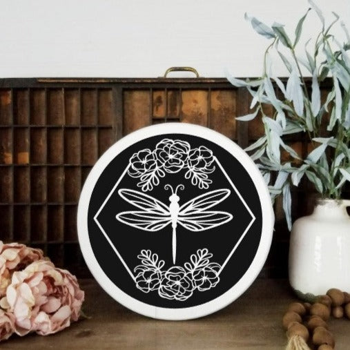 Dragonfly with floral design round sign, White with black design