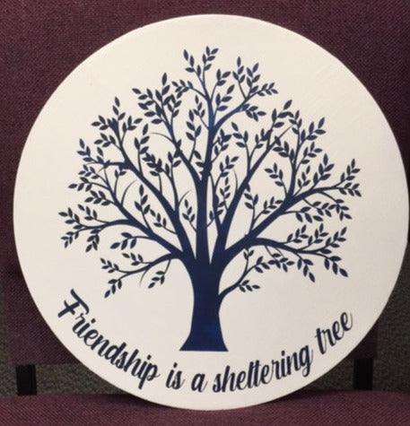 Friendship is a sheltering tree white with navy letters round sign