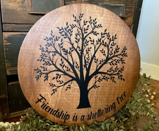 Friendship is a sheltering tree round sign