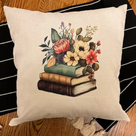 Cotton Canvas pillow cover with a stack of 3 books and a flowers arrangement  on top