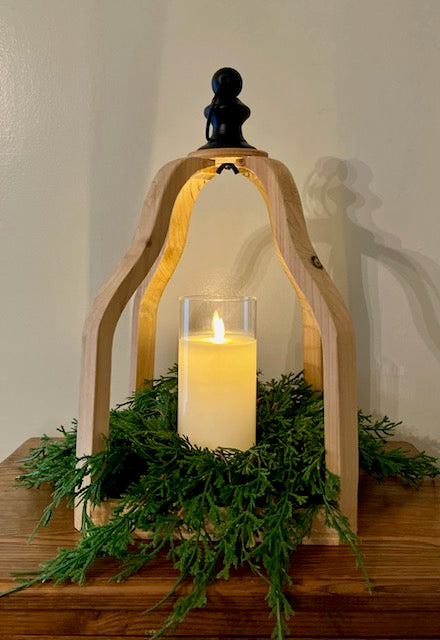 Large open wood lantern shown with cream led candle and Draping cedar candle ring