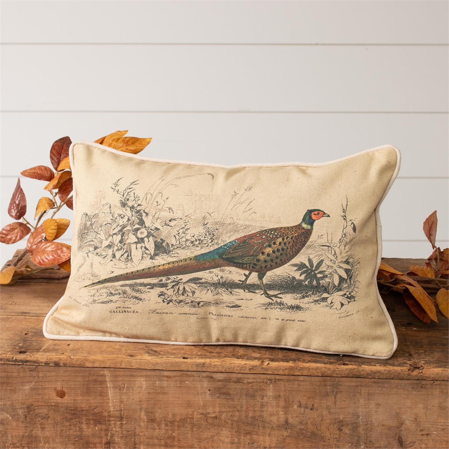 Pheasant pictured walking in a wooded background. This pillow is cream colored cotton fabric. 10" h x 16" w. 