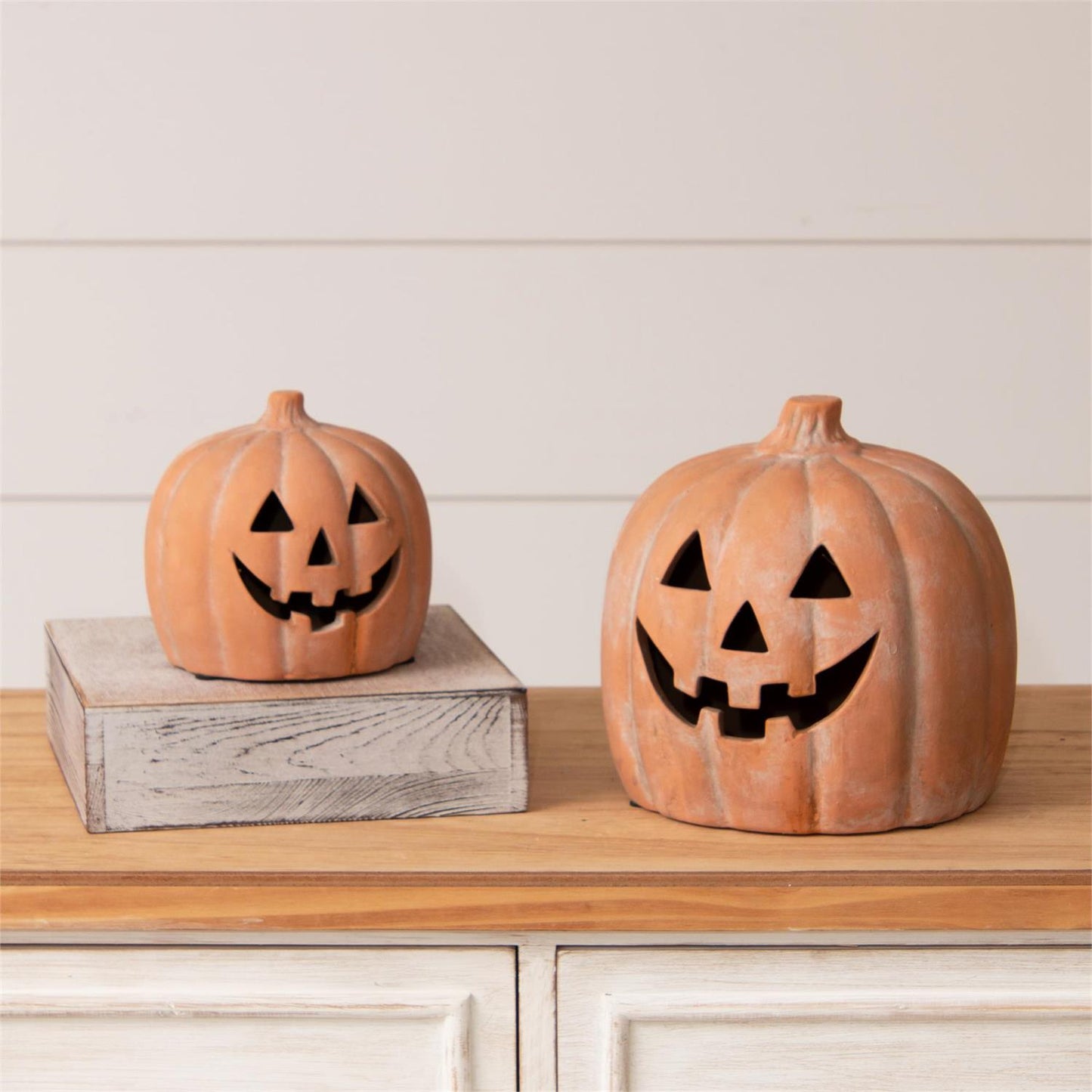 Small and large ceramic Jack O Lantern pumpkin in terra cotta finish with white wash. 