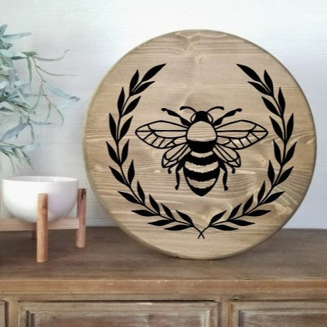 Round sign with bee and laurel leaves 